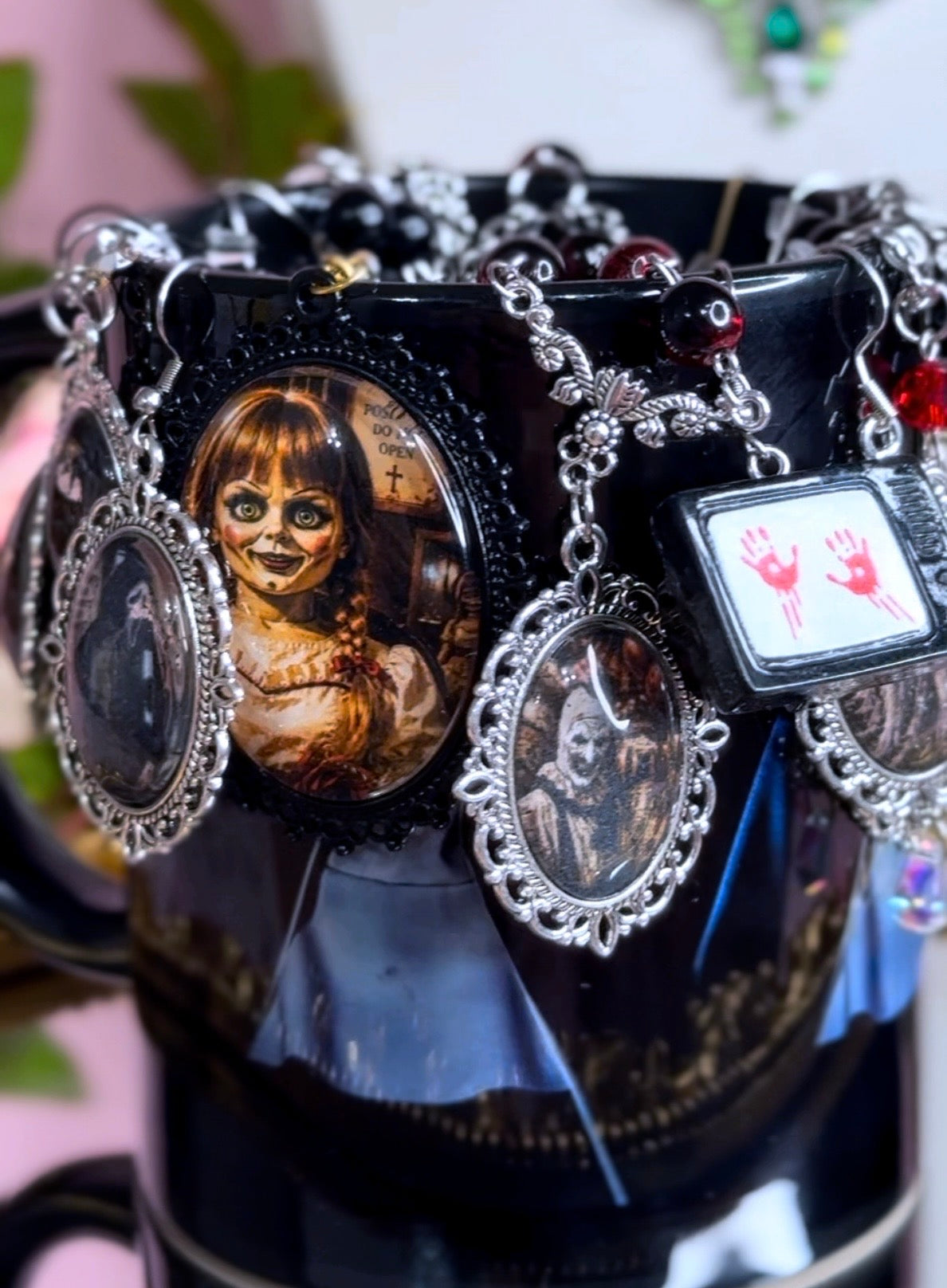 Close-up of the 9 Circles of Hell extra creepy horror mystery jewelry jar with Annabelle-style doll and haunted portrait pieces