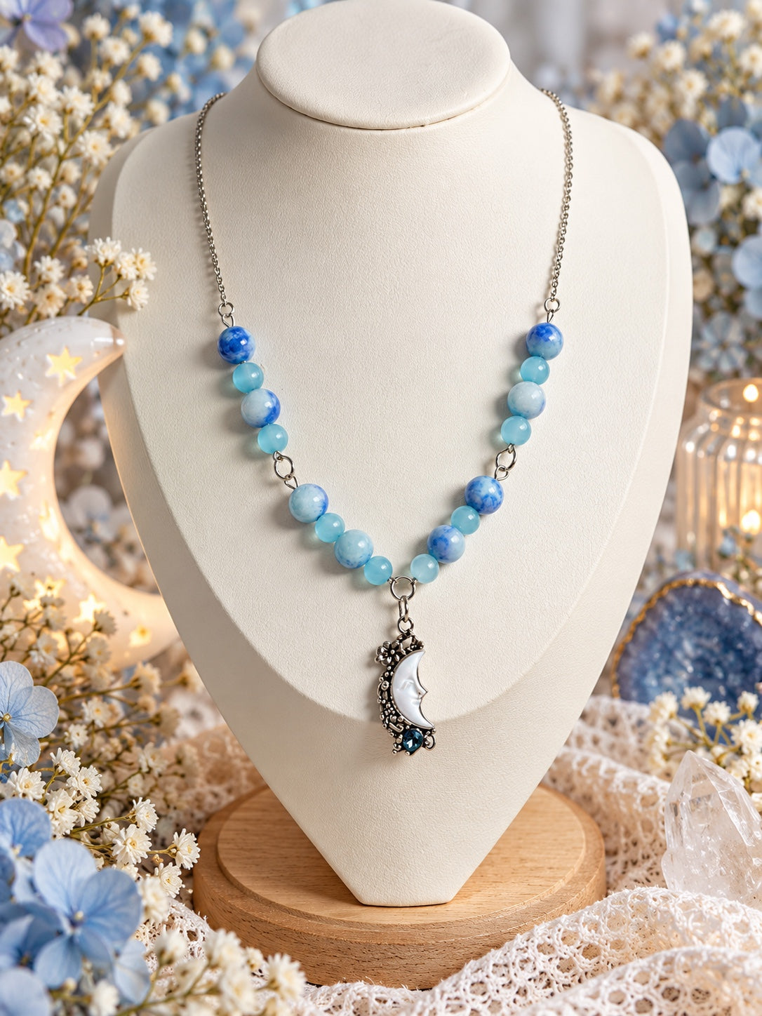Celestial necklace with blue and aqua beads and an ornate silver-tone crescent moon face pendant