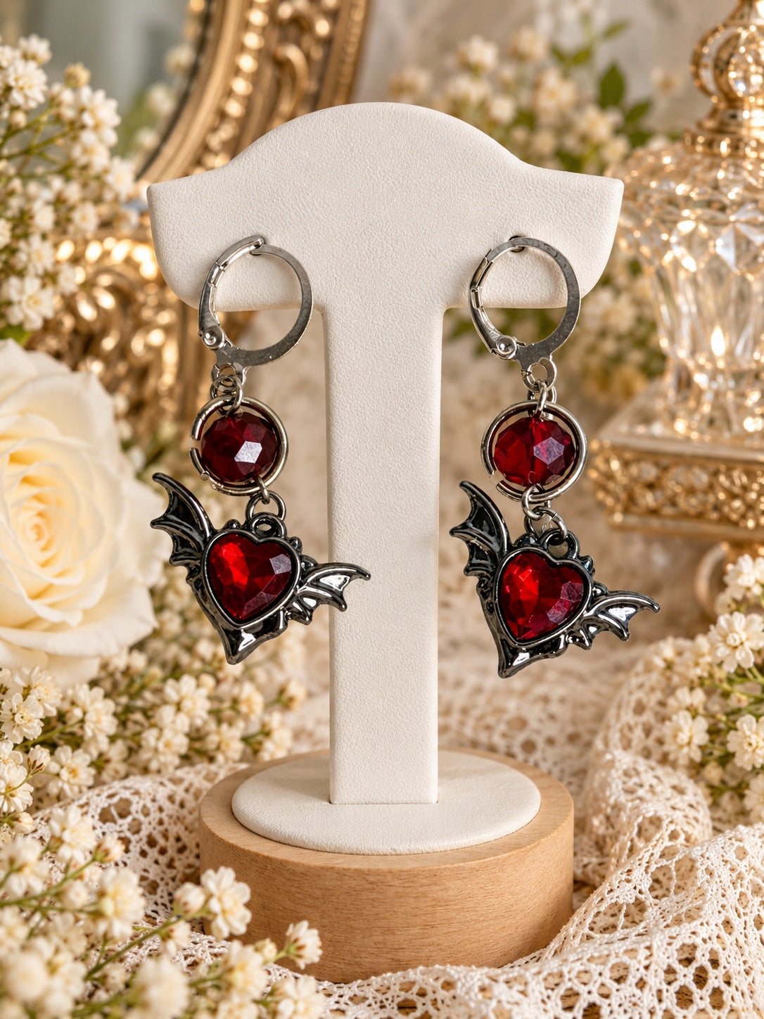 Bloodflutter Heart Earrings with faceted red hearts, bat wings, round red accents and silver-tone leverback closures