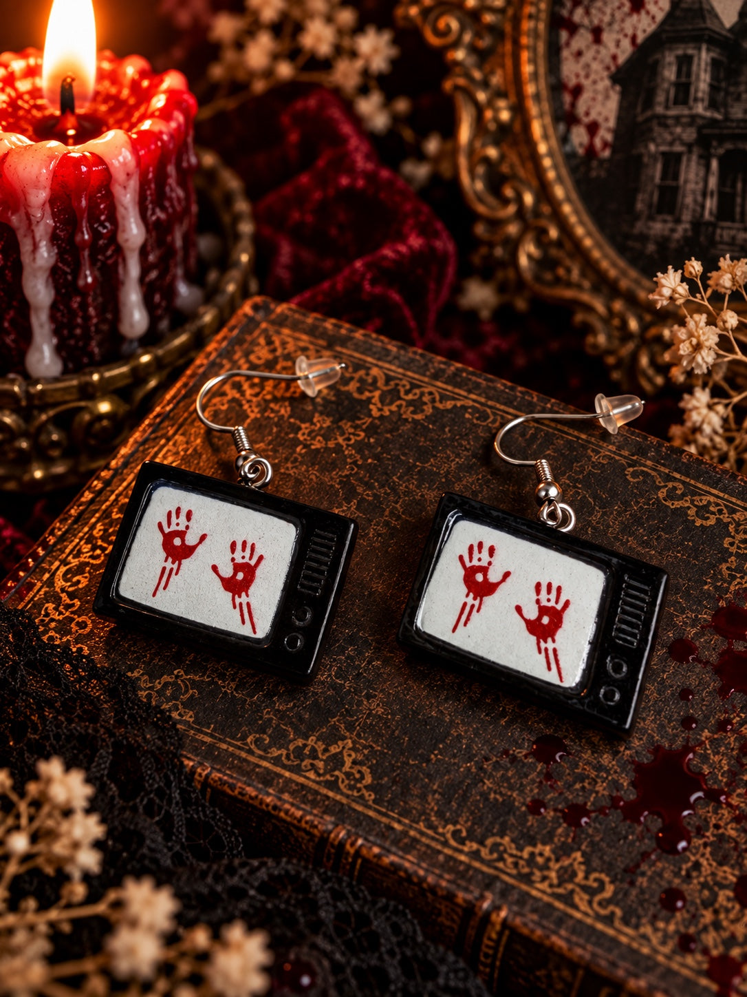 Black vintage television earrings with red bloody handprints on the screens.