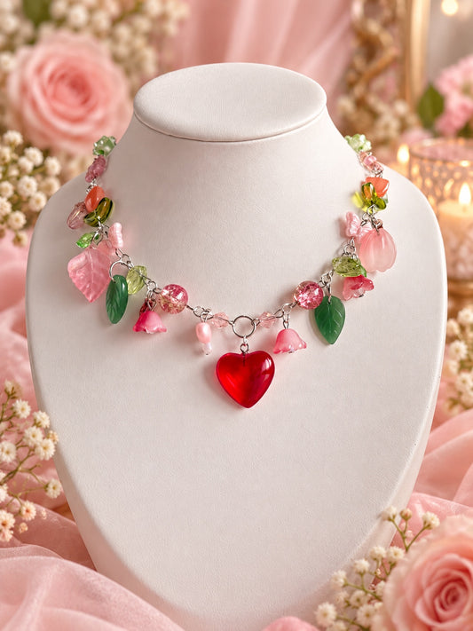Handmade fairycore cottagecore necklace with pink flowers, green leaves and red heart pendant