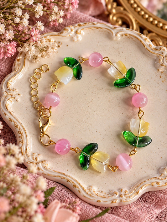 Blushpetal Tulip Bracelet with yellow and white tulip beads, green leaves, pink round beads and gold-tone links