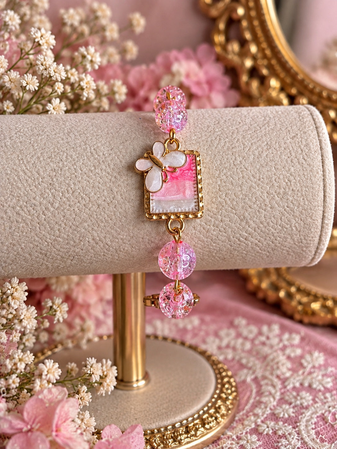 Handmade pink and gold bracelet with sparkling pink beads, floral glass centerpiece and dragonfly charm