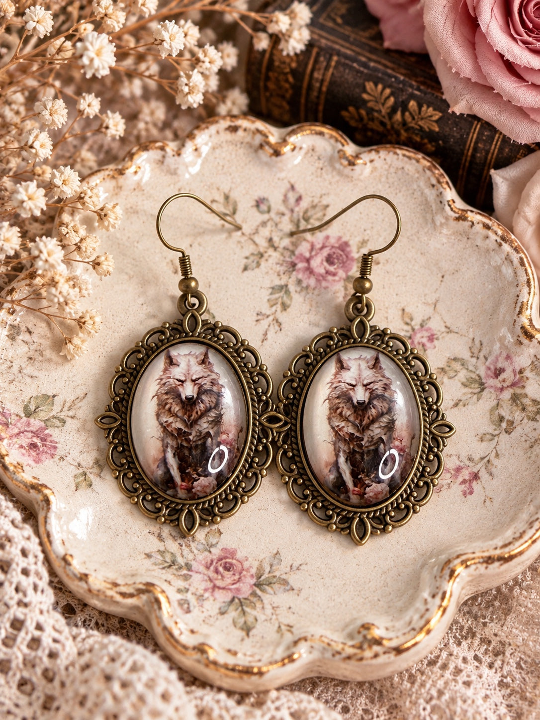 Antique bronze-tone oval wolf cameo earrings with ornate frames and French hook closures