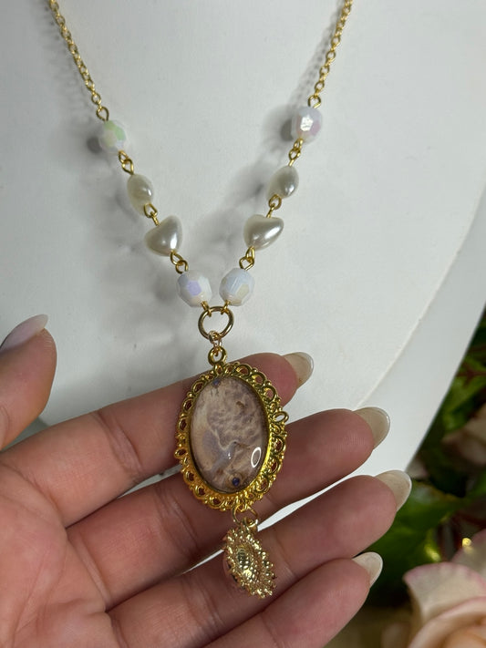 Close-up detail of the Celestine Pearlheart angelcore necklace and ornate pendant
