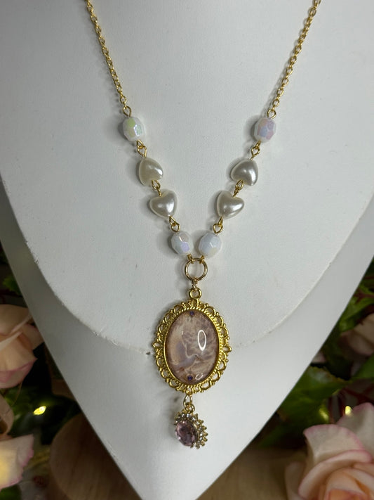 Full view of the Celestine Pearlheart angelcore necklace on a display stand