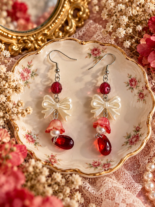 Cottagecore earrings with red faceted beads, cream bows, red flower bells, faux pearls and red teardrop pendants