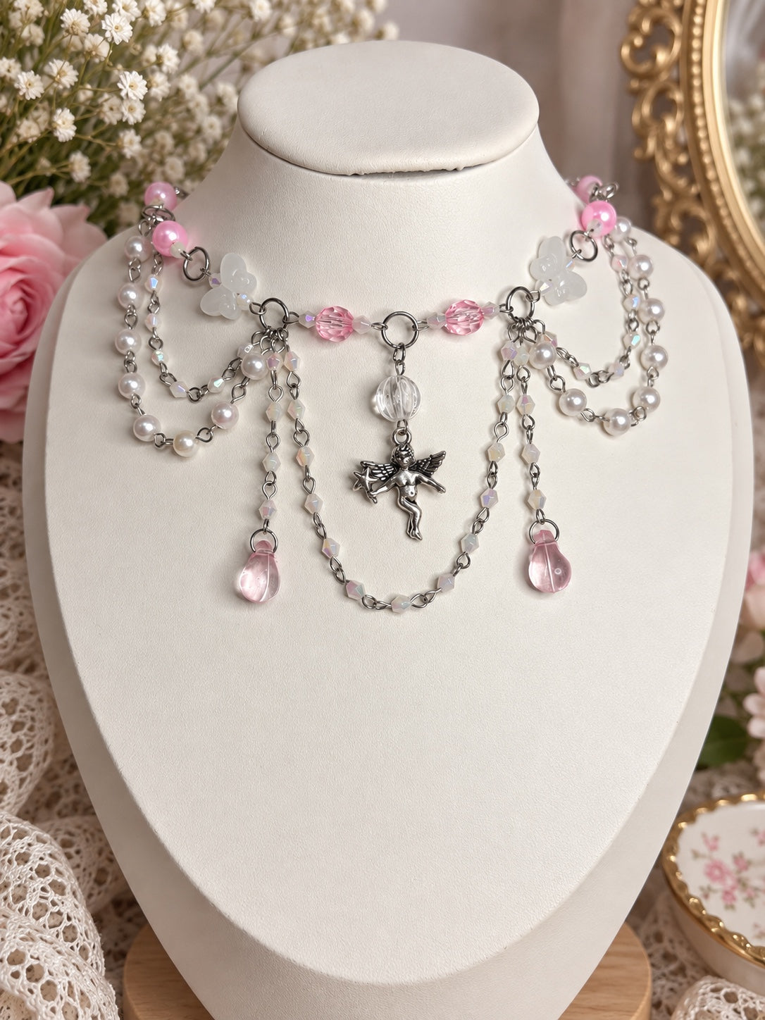 Pink and white angelcore statement necklace with pearls, butterflies, crystal drops and silver cherub charm