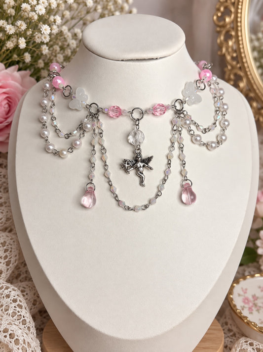 Pink and white angelcore statement necklace with pearls, butterflies, crystal drops and silver cherub charm
