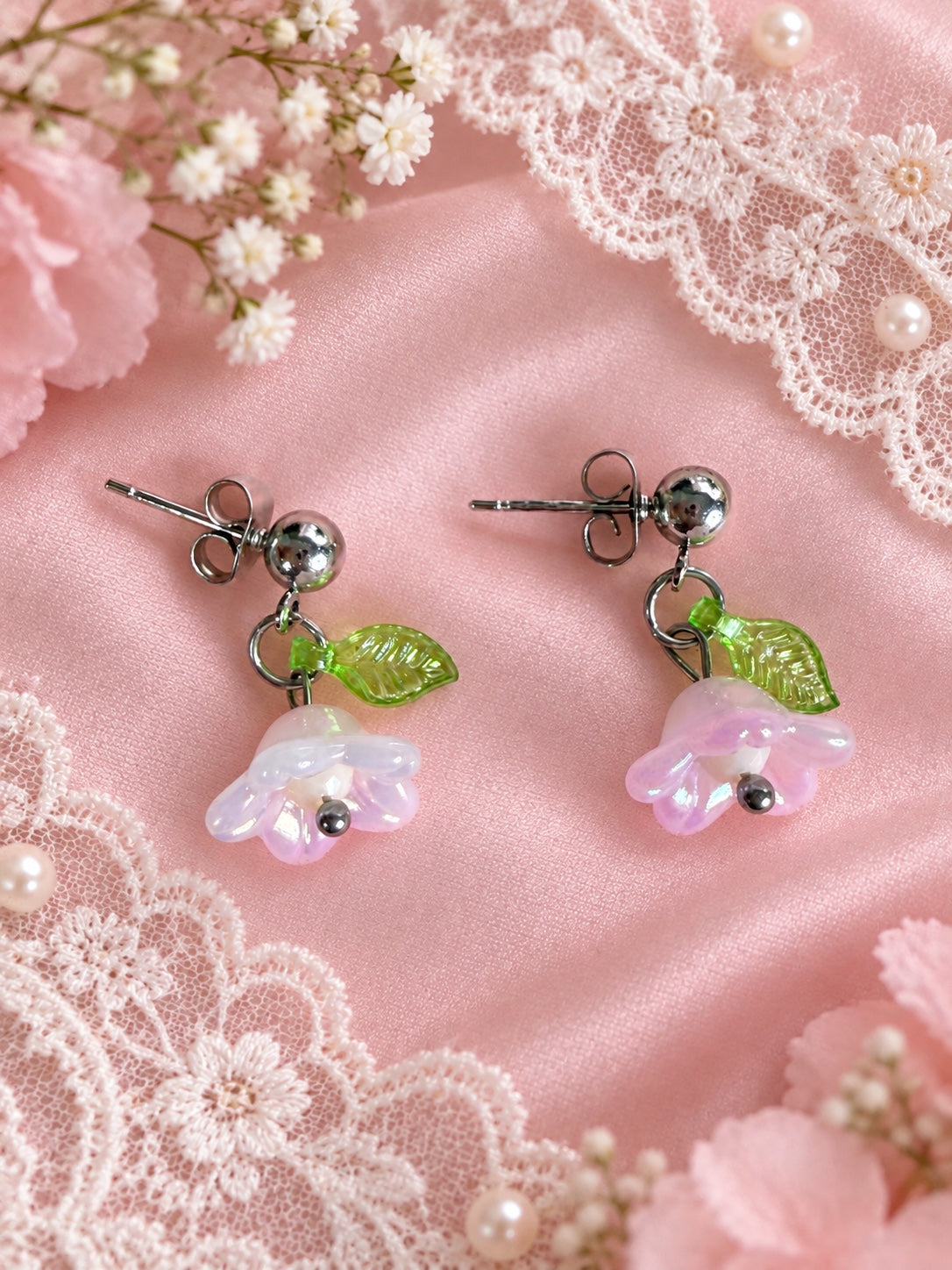 Handmade pink flower drop earrings with green leaf charms and silver-tone studs