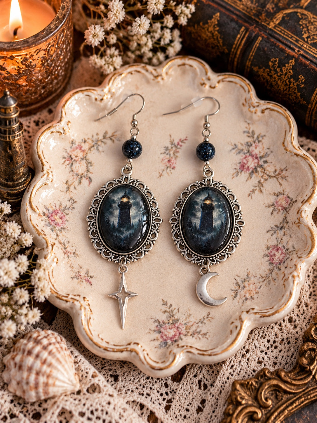 Silver-tone lighthouse cameo earrings with dark blue beads and mismatched crescent moon and star charms