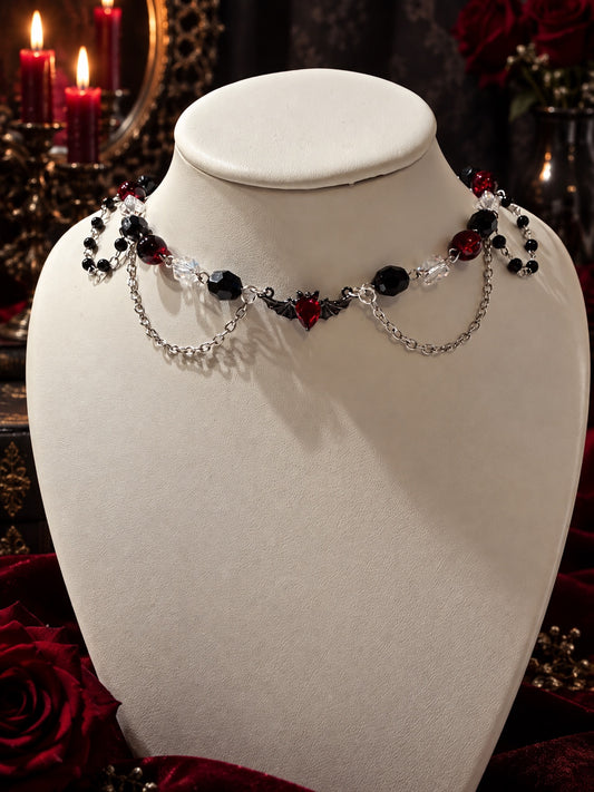 Handmade gothic necklace with red, black and clear beads, silver-tone chains and a red bat centerpiece