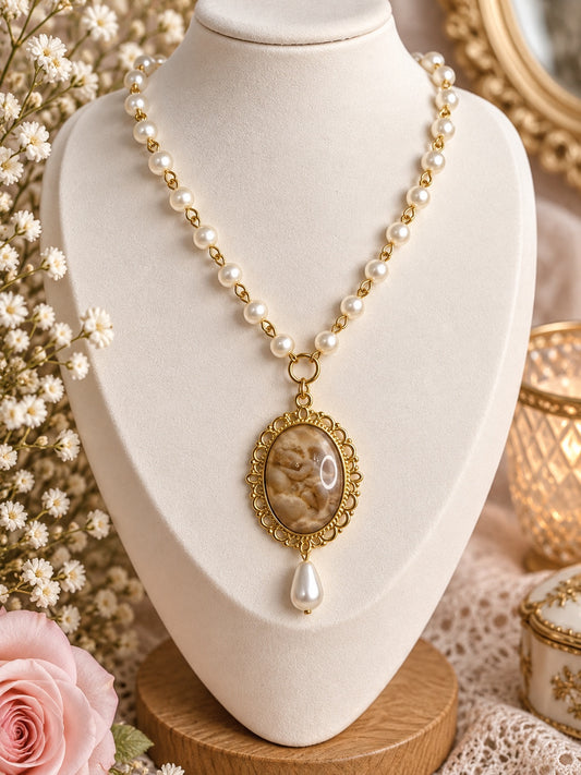 Gold-tone angel cameo necklace with ivory pearl-look beads and a teardrop pendant