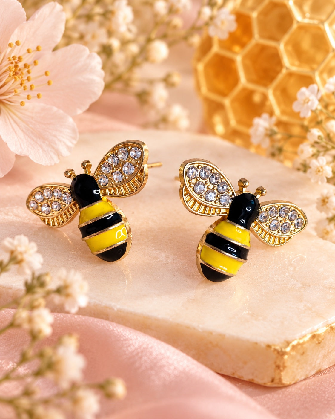 Gold-tone bee stud earrings with yellow and black stripes and sparkling clear wing accents
