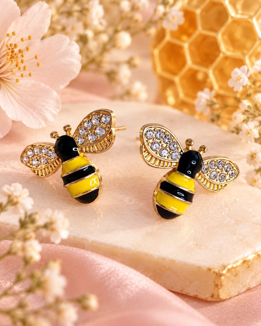 Gold-tone bee stud earrings with yellow and black stripes and sparkling clear wing accents