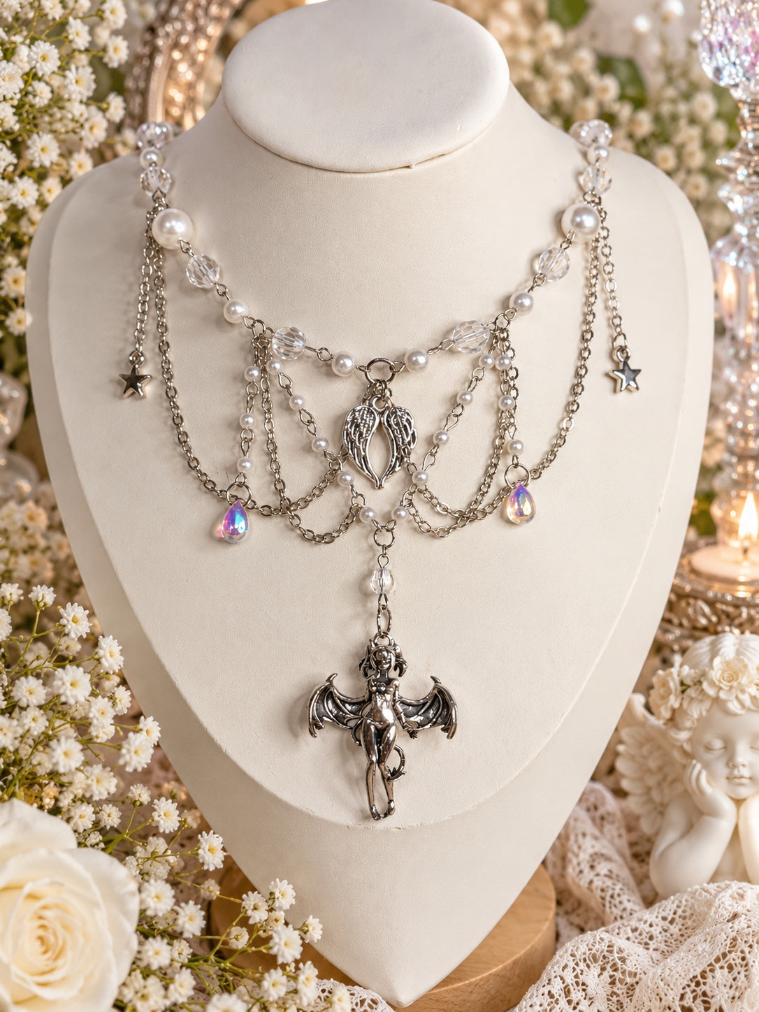Ivoryfall Enchantress Necklace with faux pearls, clear beads, silver-tone draped chains, wings, stars and a bat-winged female pendant