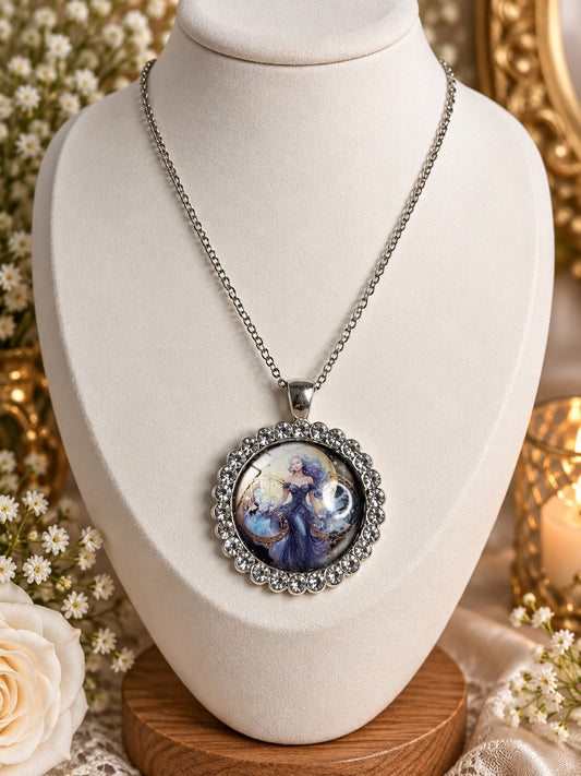 Silver-tone celestial cameo necklace with blue and violet artwork and a clear rhinestone border