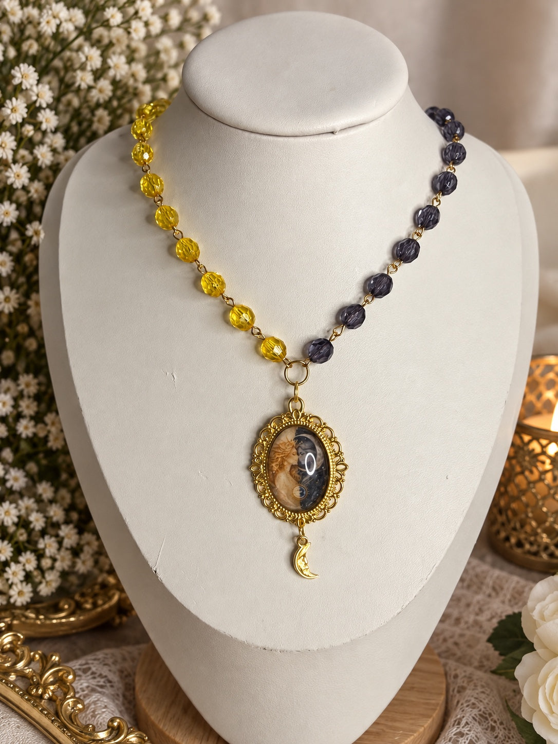 Celestial gold-tone necklace with yellow and dark purple beads, sun and moon cameo and crescent charm