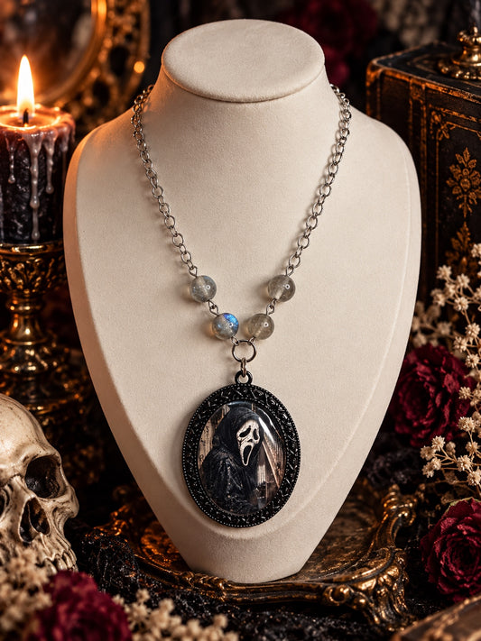 Ghostface portrait necklace with an ornate black oval frame, grey beads and silver-tone chain