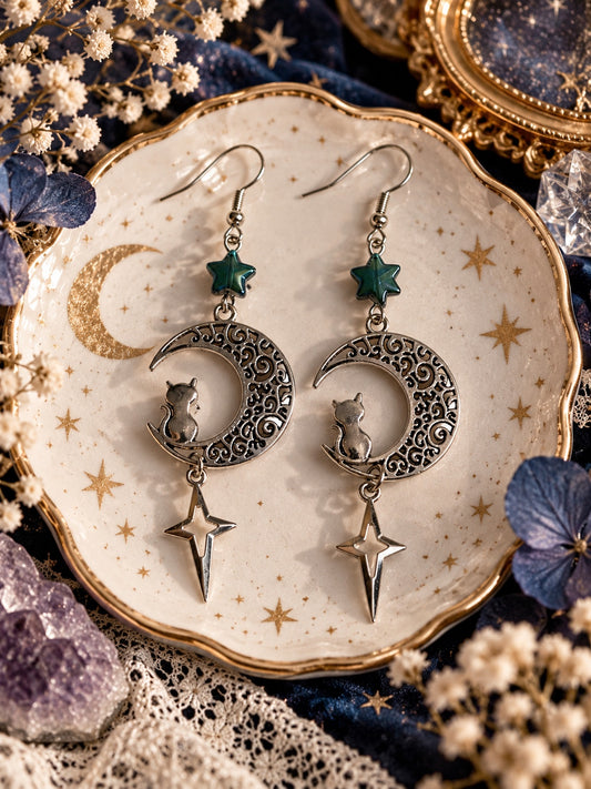 Silver-tone filigree crescent moon earrings with seated cats, teal star beads and elongated dangling stars