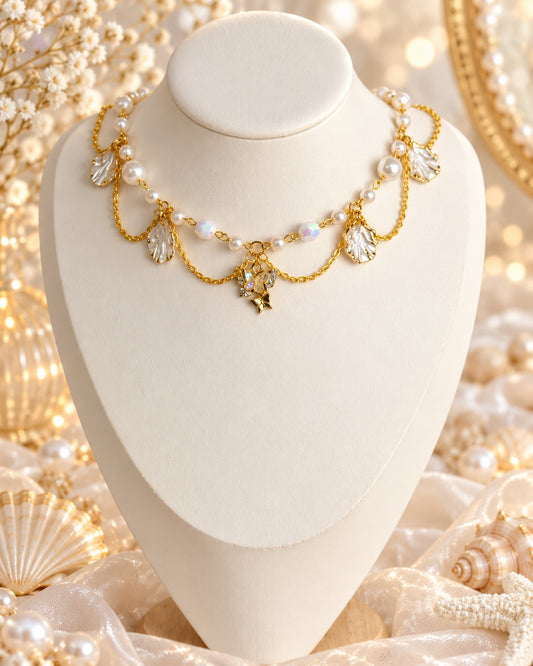 Opalwing Garland Necklace with white pearl-style beads, pearly leaf-shaped charms, draped gold-tone chains and a sparkling butterfly and star centre