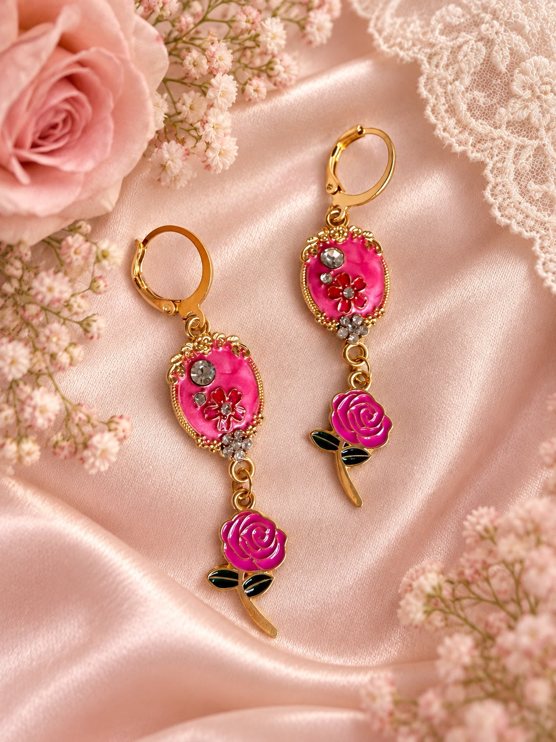 Gold-tone drop earrings with bright pink ornate floral centers, sparkling accents and pink rose charms
