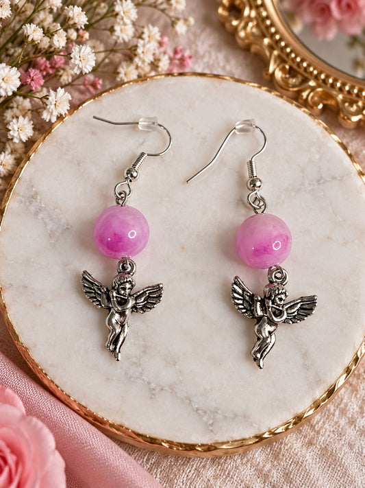Silver-tone dangling cherub earrings with translucent pink round beads