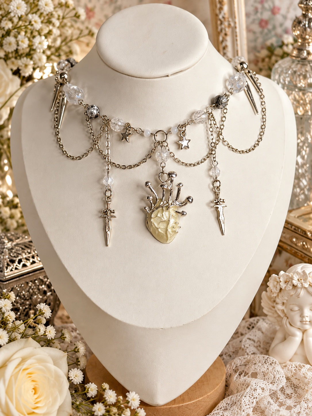 Spectralpulse Heart Necklace with an ivory glow-in-the-dark anatomical heart, silver-tone swords, stars, spikes and clear beads