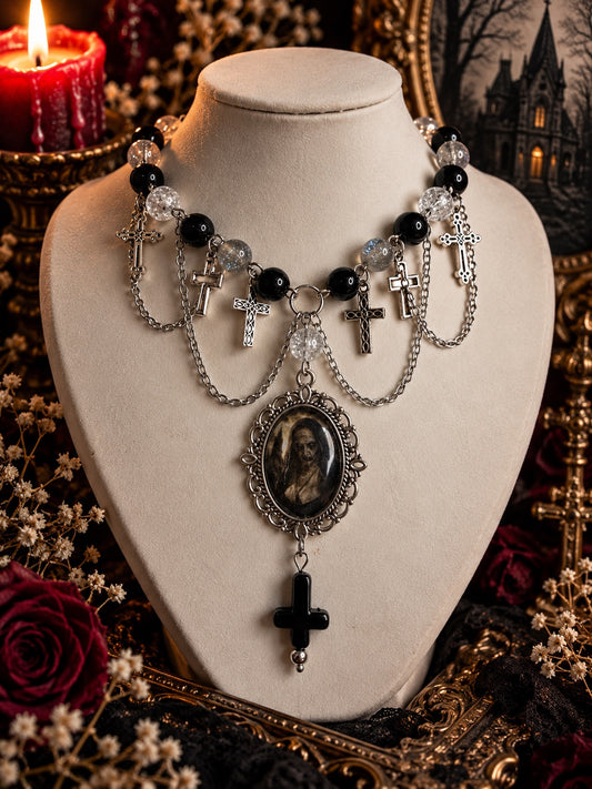 Layered horror necklace with black and clear beads, silver-tone cross charms, a haunting nun cameo and a black inverted cross.