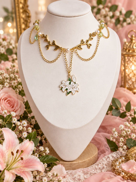 Gold-tone layered necklace with leafy branch details, pale green beads, white pearl-style beads and a white lily pendant.