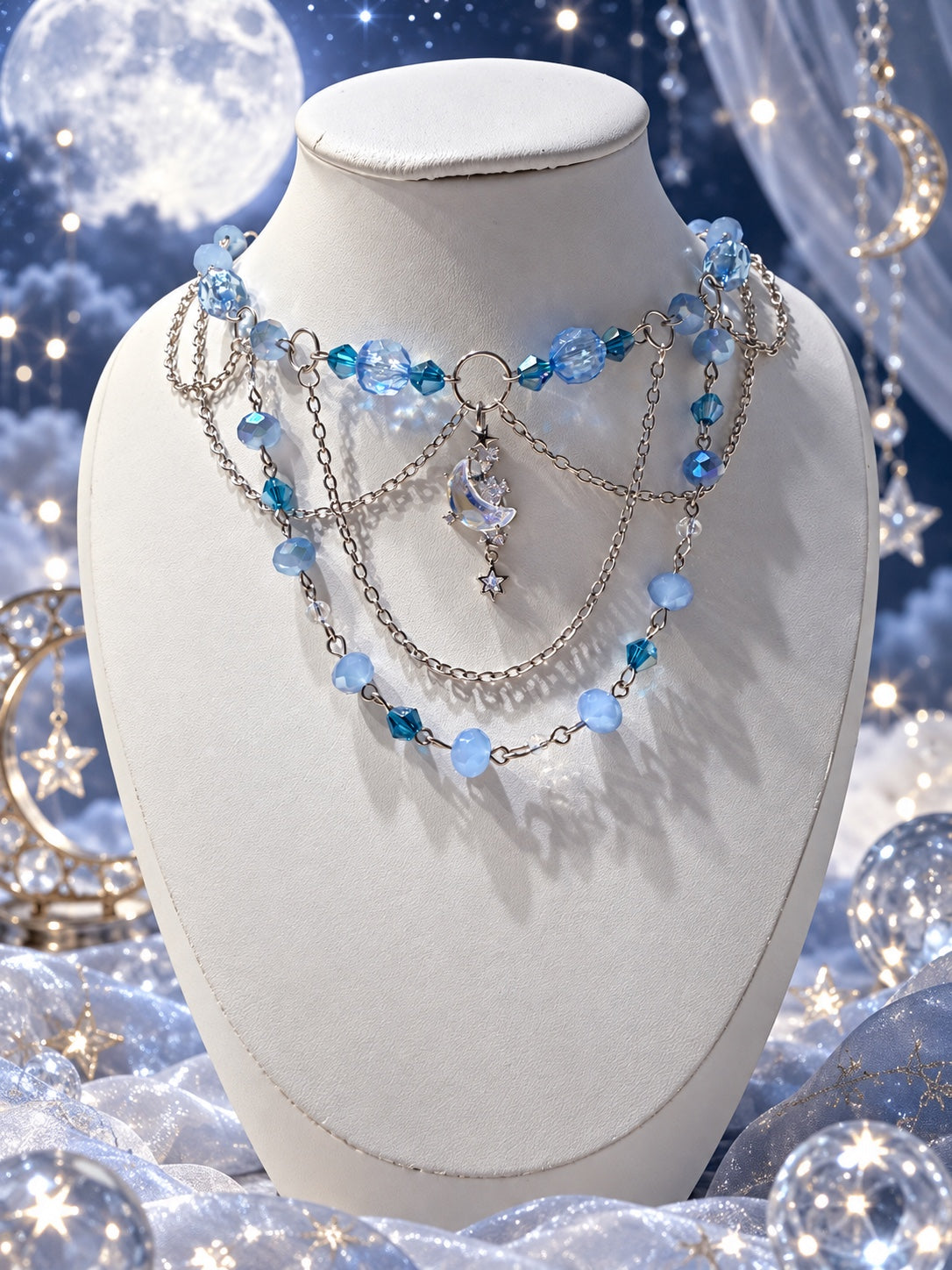 Blue celestial layered necklace with silver-tone chains, pale blue and teal faceted beads, an iridescent crescent moon and dangling star details.