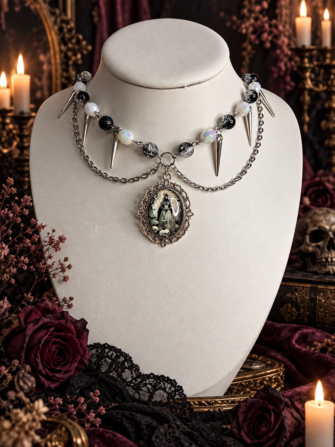 Gothic silver-tone necklace with black and iridescent white beads, spike charms, draped chains and a skeletal figure cameo