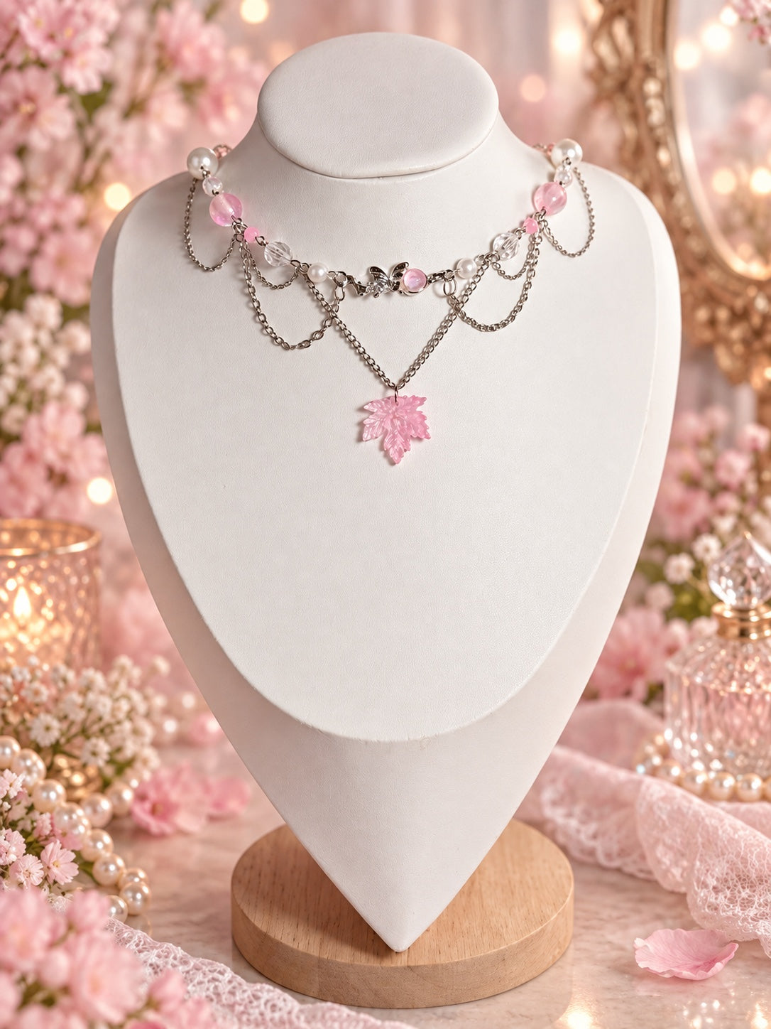 Silver-tone layered necklace with pink and clear beads, faux pearls, a small fairy centrepiece and a pink leaf pendant.