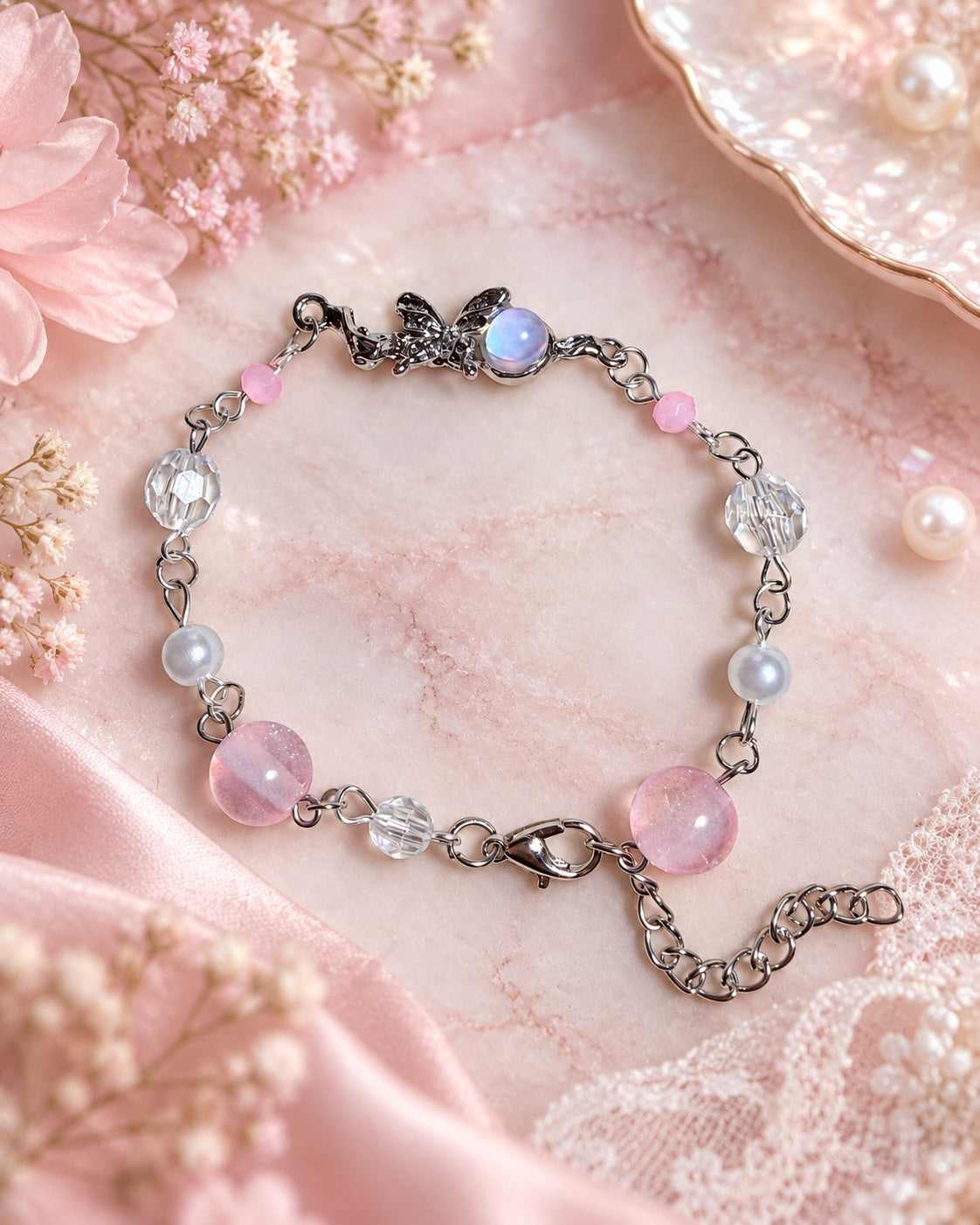 Silver-tone fairy bracelet with an iridescent orb, pink and clear beads, faux pearls and an adjustable extension chain