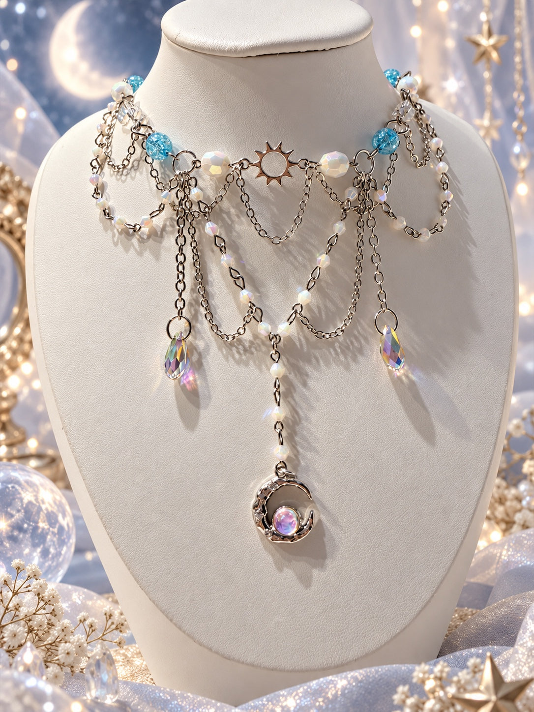 Celestial layered silver-tone necklace with white iridescent beads, aqua blue beads, a sun charm, rainbow teardrops and a crescent moon pendant.
