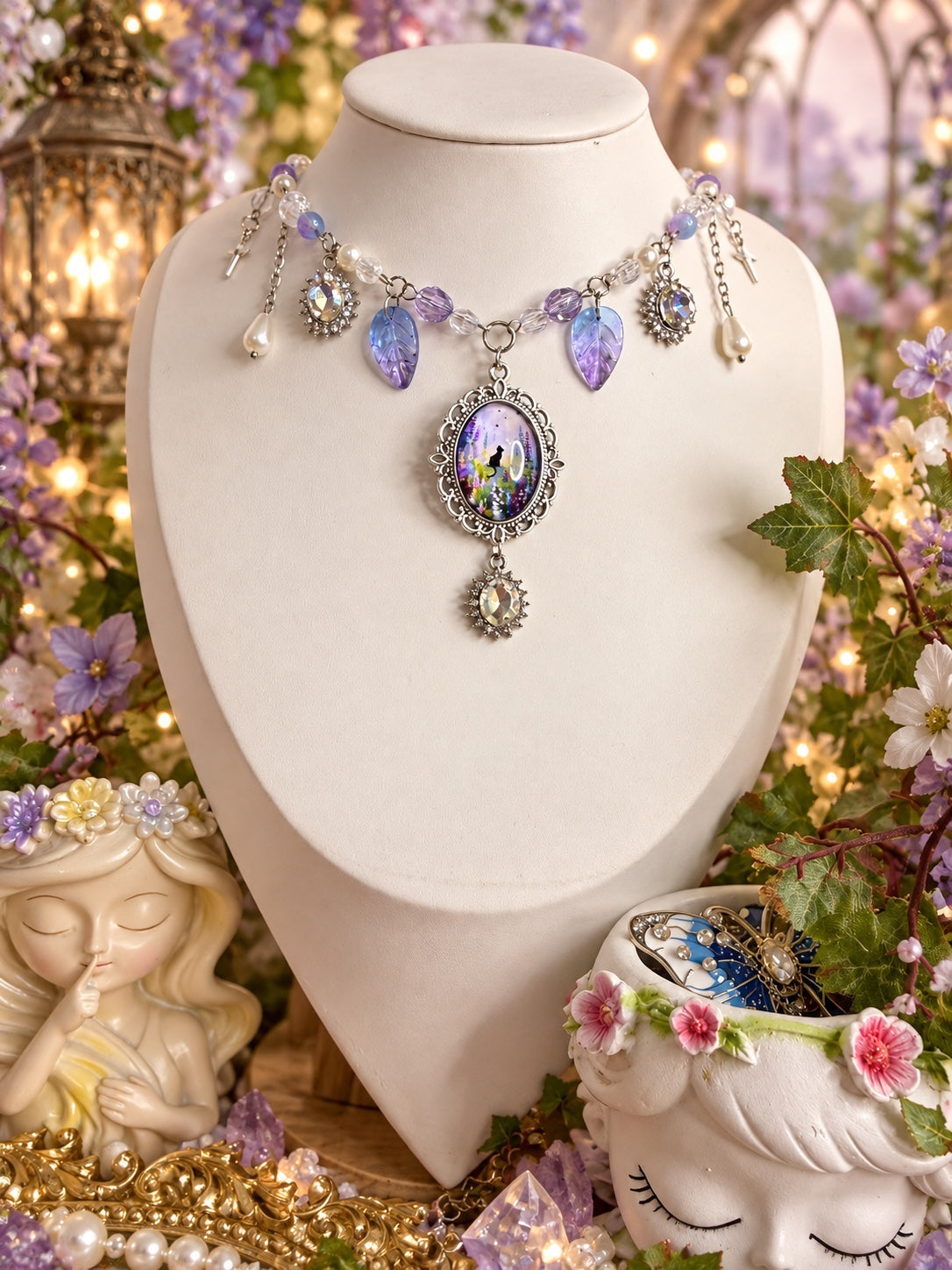 Silver-tone necklace with a purple fairy cameo, violet leaf charms, pearly drops and iridescent oval accents.