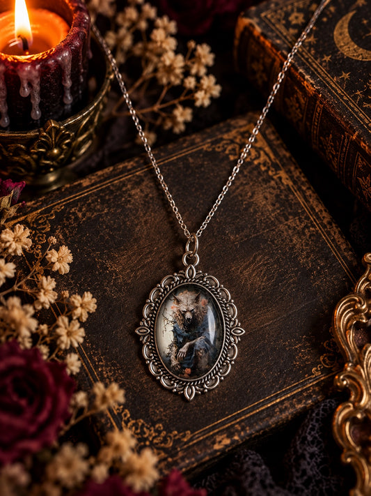 Silver-tone ornate oval necklace with a snarling wolf-like creature portrait