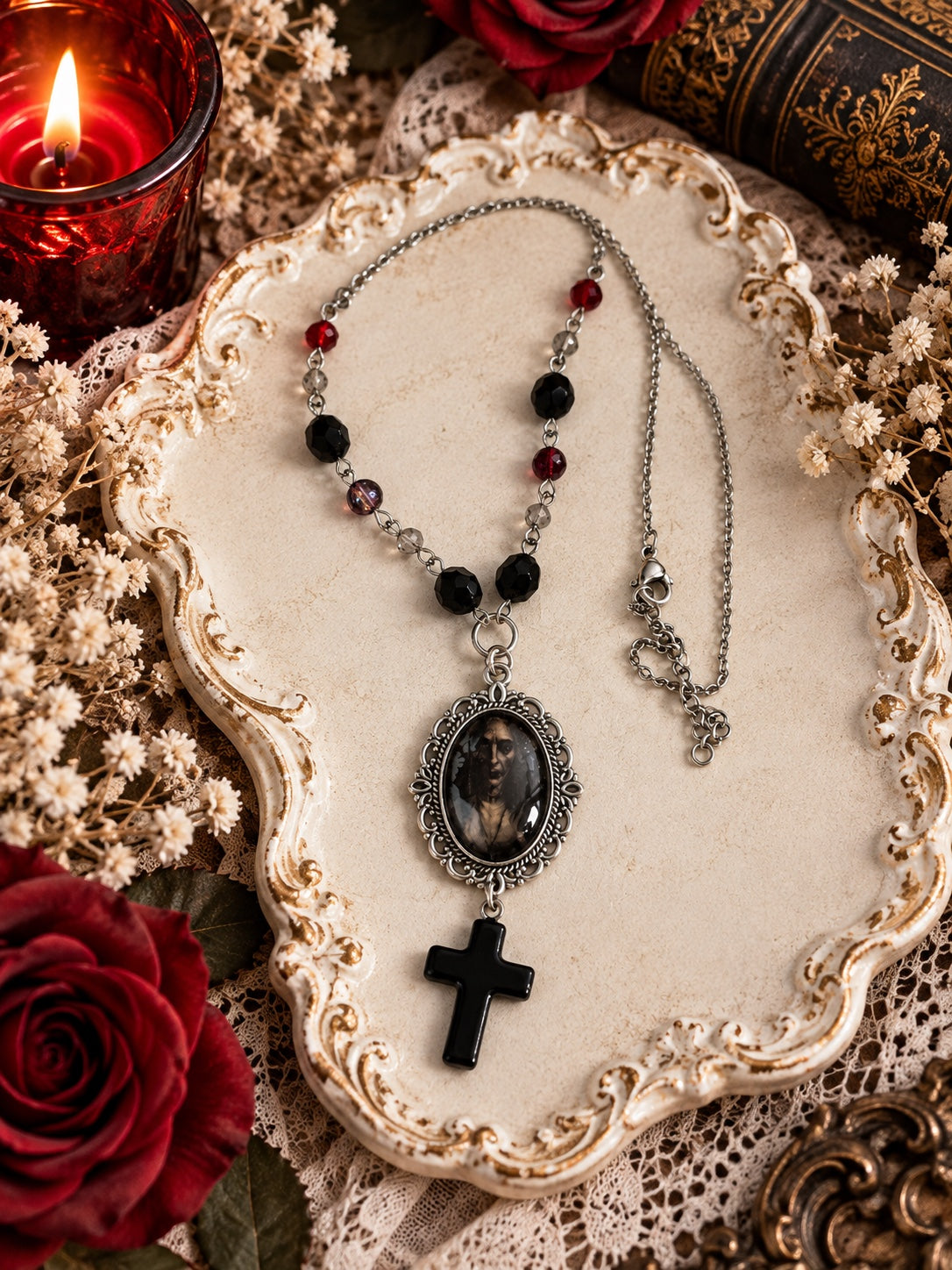Silver-tone beaded horror necklace with a haunting portrait cameo, black cross pendant and black, red and smoky clear beads