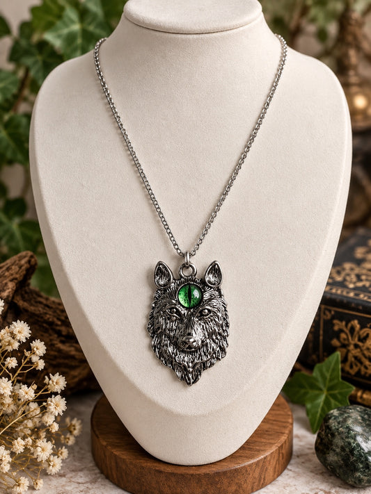 Silver-tone wolf head necklace with a green third eye on a silver-tone chain