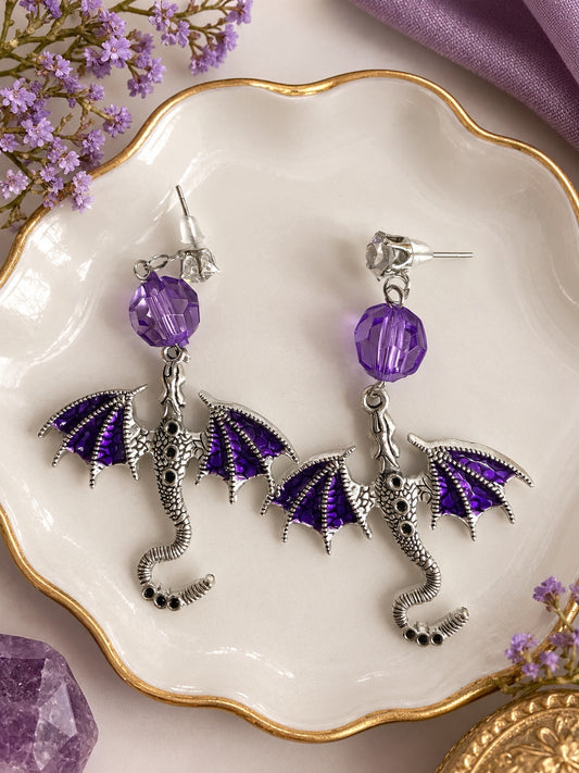 Second view of purple winged dragon drop earrings with silver-tone detailing