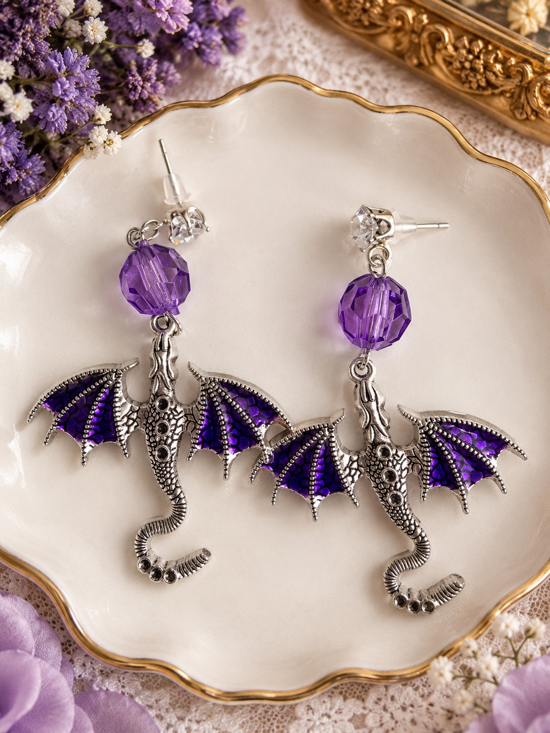 Silver-tone dragon earrings with purple wings, faceted purple beads and clear stone stud tops