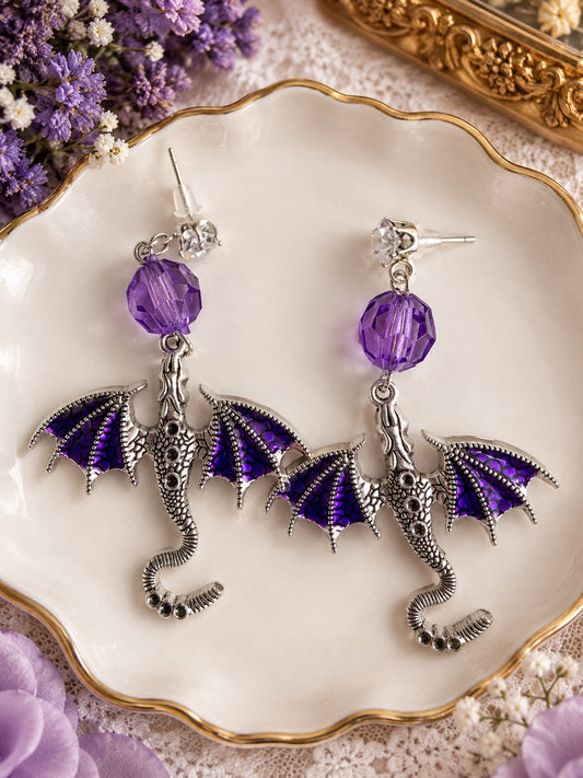 Silver-tone dragon earrings with purple wings, faceted purple beads and clear stone stud tops