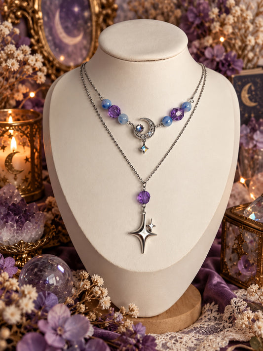 Layered silver-tone celestial necklace with blue and purple beads, a sparkling crescent moon and a long four-point star pendant