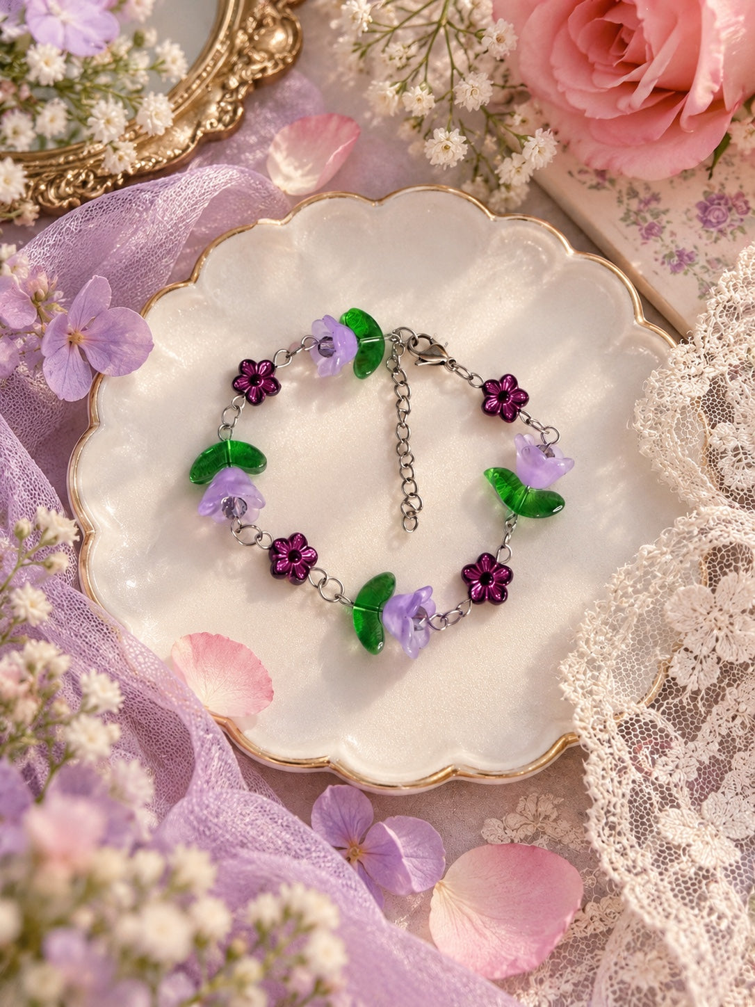 Silver-tone bracelet with lilac bell flowers, translucent green leaves and dark purple flower beads